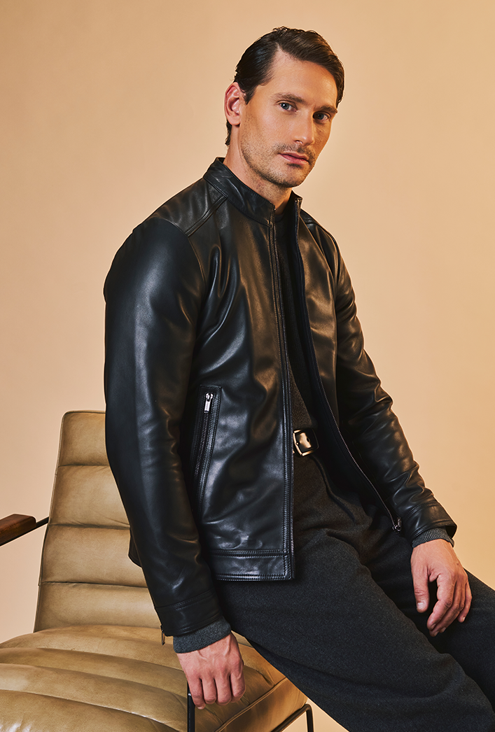 Men’s black genuine lambskin leather biker jacket with a clean, minimalist design, front zip closure, and a slim, lightweight fit. Men’s black genuine lambskin leather biker jacket with a clean, minimalist design, front zip closure, and a slim, lightweight fit.