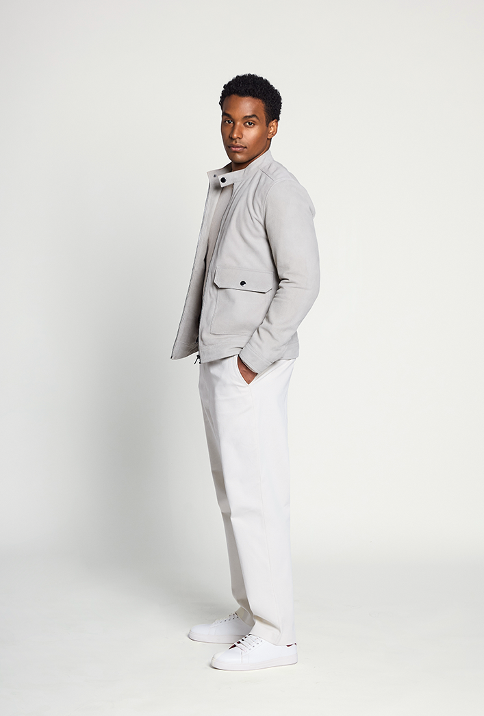 Men’s Premium goatskin grey suede jacket featuring a mandarin collar with button detail, front zip closure, flap pockets, and a tailored fit. Men’s Premium goatskin grey suede jacket featuring a mandarin collar with button detail, front zip closure, flap pockets, and a tailored fit.