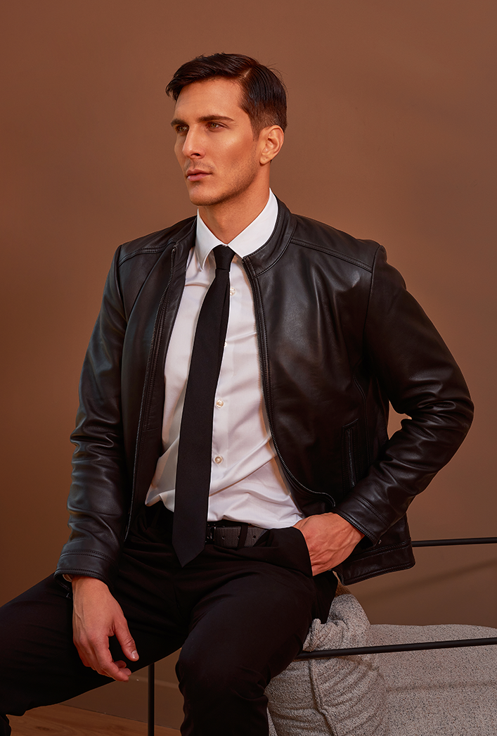 Men’s black genuine lambskin leather biker jacket with a clean, minimalist design, front zip closure, and a slim, lightweight fit. Men’s black genuine lambskin leather biker jacket with a clean, minimalist design, front zip closure, and a slim, lightweight fit.