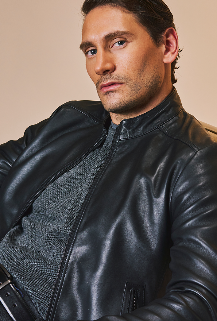 Men’s black genuine lambskin leather biker jacket with a clean, minimalist design, front zip closure, and a slim, lightweight fit. Men’s black genuine lambskin leather biker jacket with a clean, minimalist design, front zip closure, and a slim, lightweight fit.