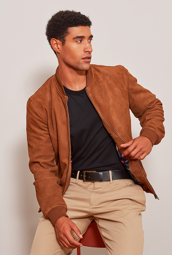 Men’s tobacco brown bomber jacket crafted from luxurious goatskin suede, featuring a sleek front zip closure and practical side pockets in a modern, tailored fit.
